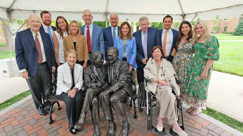 The Farmer Family Sculpture Park was dedicated earlier this month on Miami University’s main Oxford campus featuring a bronze sculpture of Richard (Dick) and Joyce Farmer. Dick Farmer, who died in 2021, was founder of the Fortune 500 Cintas Corporation and gave the Miami business school its name. The couple are financial donors to the school. Joyce Farmer is seated and surrounded by family members. CONTRIBUTED