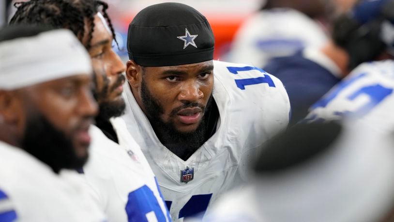 Dallas Cowboys linebacker Micah Parsons (11) sits on the bench alongside teammates in the second half of an NFL football game against the Baltimore Ravens in Arlington, Texas, Sunday, Sept. 22, 2024. (AP Photo/Jeffrey McWhorter)