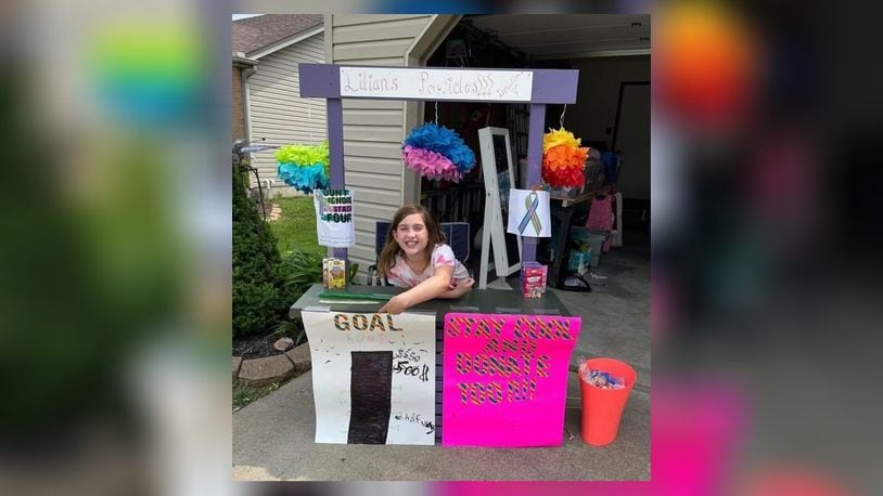 Lilian Moore, 11, of Trenton, raised more than $6,000 during her three-day Popsicle Stand sale during the city’s annual garage sale. She donated the money to help people with stage IV breast cancer. CONTRIBUTED