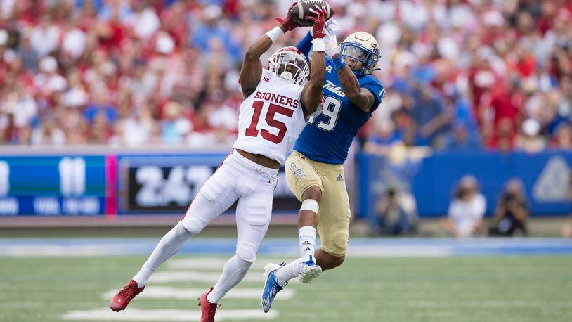 Oklahoma defensive back Kendel Dolby (15) intercepts a ball intended for Tulsa wide receiver Devan Williams (19) during the first half of an NCAA college football game Saturday, Sept. 16, 2023, in Tulsa, Okla. (AP Photo/Alonzo Adams)