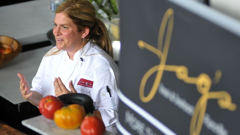 Chef Michelle Brown of Jag’s Steak & Seafood in West Chester Twp. performs a cooking demonstration in August 2015 at the Western & Southern Open in Mason. MICHAEL D. PITMAN/STAFF