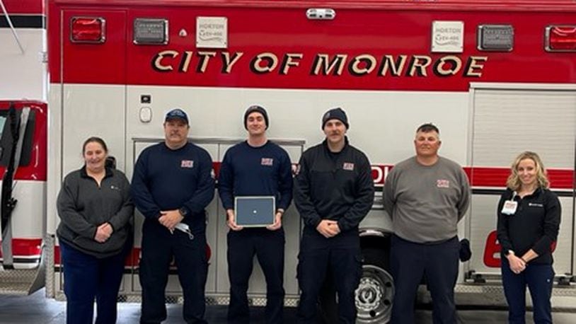 Members of the Monroe Fire Department received the first Challenge Coins from Atrium Medical Center, part of Premier Health. They were recognized for going 'above and beyond' when they used a treatment technique that may have saved a gunshot victim's life. From left, Ann Brock, trauma outreach coordinator at Atrium, firefighters Joel Coomer, Jacob Zeckser, Todd Lohse, Lt Rusty Rickard and Claire Hardman, trauma program manager at Atrium. They removed their masks for the picture, then put them back on. CONTRIBUTED