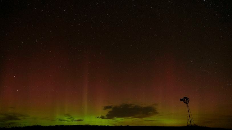 An aurora borealis, also known as the northern lights, is seen in the night sky behind a windmill water pump on Tuesday, Sept. 24, 2024, near Washtucna, Wash. (AP Photo/Ted S. Warren)