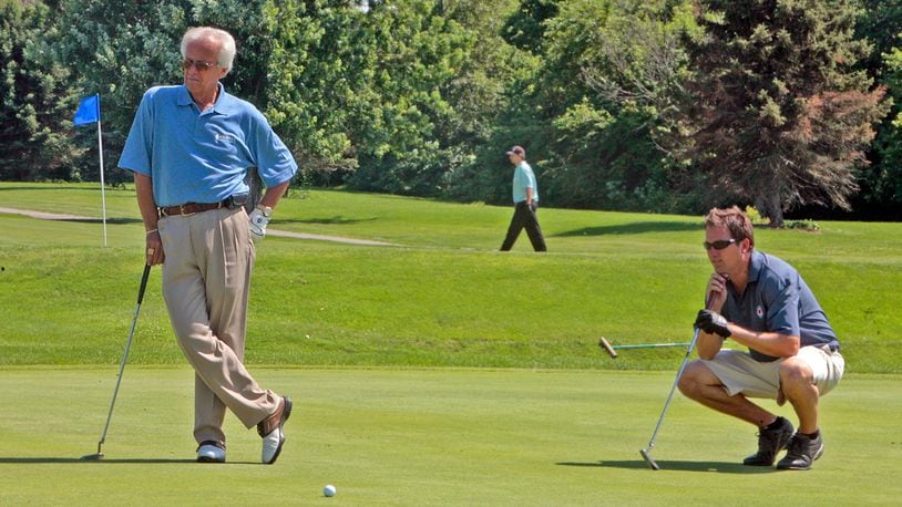 Marty Brennaman, long-time broadcast partner of the late Joe Nuxhall, and Steve Burns watch as another golfer make a put Monday, June, 16, 2008, during the Joe Nuxhall Scholarship Foundation golf outing at the Hamilton Elks Golf Club in Hamilton, Ohio. FILE PHOTO