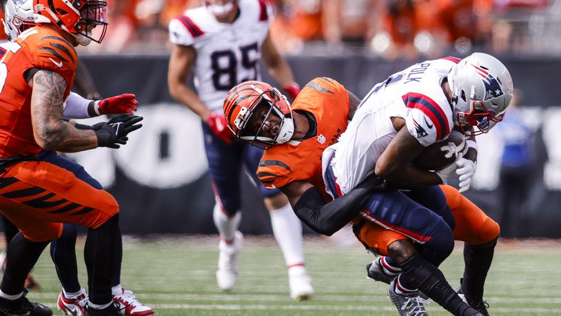 Bengals cornerback Dax Hill tackles Patriots wide receiver Ja'Lynn Polk during their 16-10 loss to New England Patriots Sunday, Sept. 8, 2024 at Paycor Stadium in Cincinnati. NICK GRAHAM/STAFF