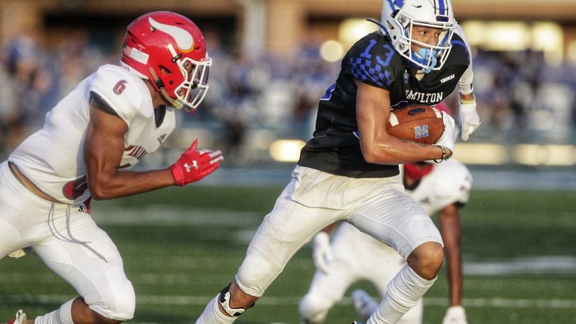 Hamilton wide receiver Daryan Bowling looks to outrun Princeton safety Leroy Bowers during their season-opening game at Virgil Schwarm Stadium on Aug. 28, 2020. Nick Graham/STAFF