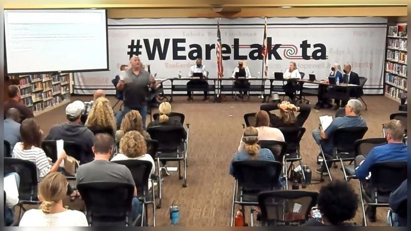 Brian Oswald, pictured standing before the audience at the Sept. 27, 2021, Lakota School Board meeting, claims the board violated his freedom of speech by stopping him from addressing parents of the district. School board policy states all commenters must address the presiding officer of the board. SCREEN CAPTURE/YOUTUBE.COM