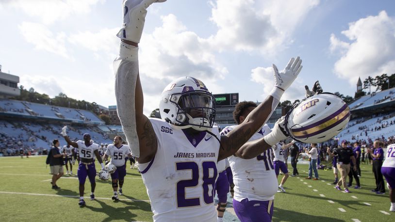 James Madison running back Jobi Malary (28) celebrates with fans after an NCAA college football game against North Carolina in Chapel Hill, N.C., Saturday, Sept. 21, 2024. (Daniel Lin/Daily News-Record via AP)