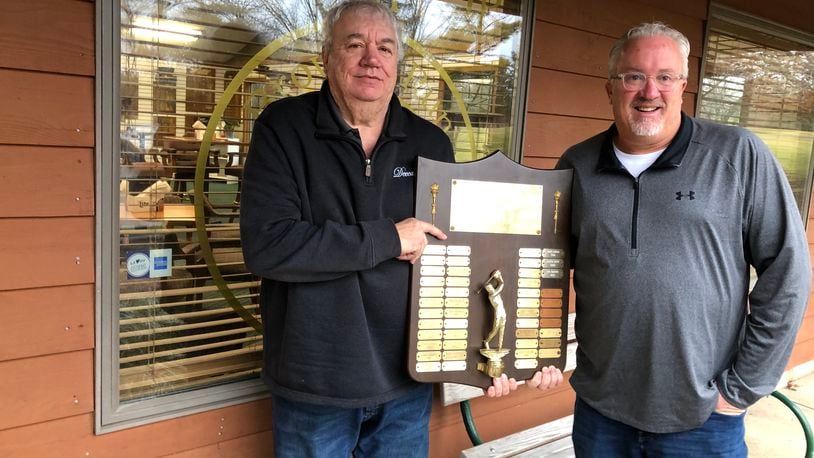 Jim Kraft, left, head professional at Brown's Run Country Club, and Scott Dalton, director of golf operations, are resurrecting the Middletown city golf tournament. They're holding the trophy that hung in Weatherwax Golf Course for years. RICK McCRABB/STAFF