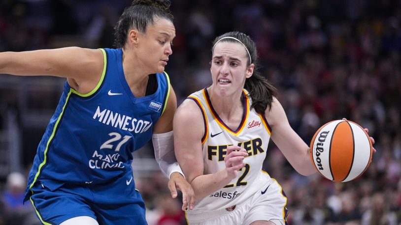 Indiana Fever guard Caitlin Clark (22) drives on Minnesota Lynx guard Kayla McBride (21) in the second half of a WNBA basketball game in Indianapolis, Friday, Sept. 6, 2024. (AP Photo/Michael Conroy)