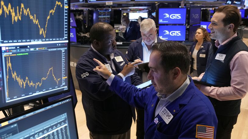 Specialist Genaro Saporito, foreground, works with traders at his post on the floor of the New York Stock Exchange, Wednesday, Sept. 18, 2024. (AP Photo/Richard Drew)