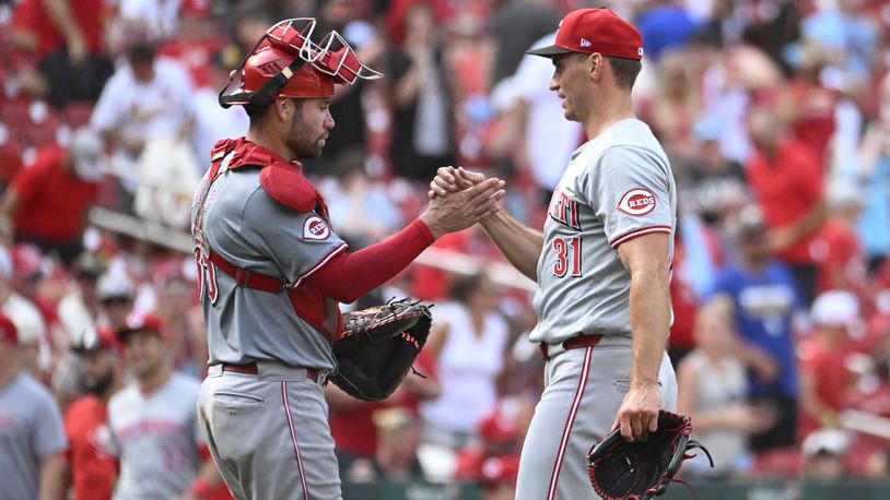 Cincinnati Reds catcher Austin Wynns, left, celebrates with teammate Brent Suter, right after defeating the St. Louis Cardinals in a baseball game, Saturday, June 29, 2024, in St. Louis. (AP Photo/Joe Puetz)