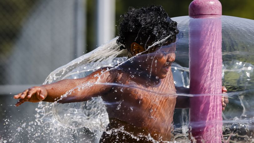 James Betances, 5, plays in the water at the sprayground Tuesday, Aug. 22, 2023 at Booker T. Washington Community Center in Hamilton. NICK GRAHAM/STAFF