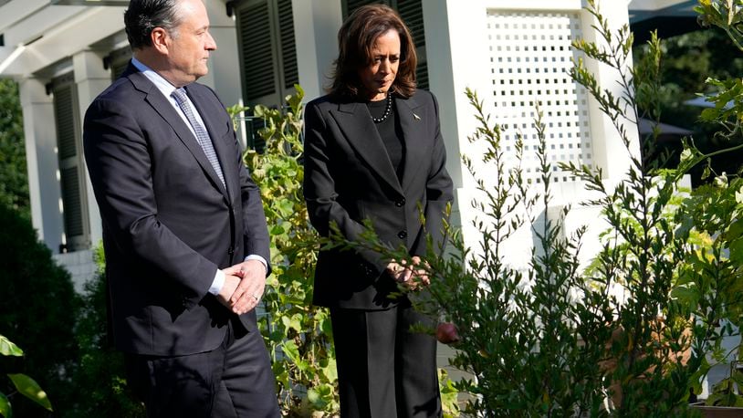 Democratic presidential nominee Vice President Kamala Harris, right, and second gentleman Doug Emhoff stand after planting a memorial tree on the grounds of the Vice President's residence in Washington on Monday, Oct. 7, 2024, to honor the victims and mark one year since the Oct. 7, 2023, Hamas attack on Israel. (AP Photo/Ben Curtis)