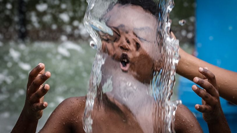 Kids and adults enjoyed the splash pad at Island MetroPark Tuesday June 18, 2024. This week temperatures are in the mid-90s with heat index, or "feels like" temperatures around 100 degrees. JIM NOELKER/STAFF