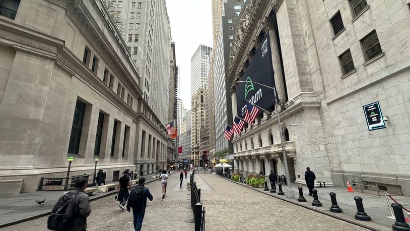 The New York Stock Exchange, right, is shown on Tuesday, Oct. 1, 2024, in New York. (AP Photo/Peter Morgan)