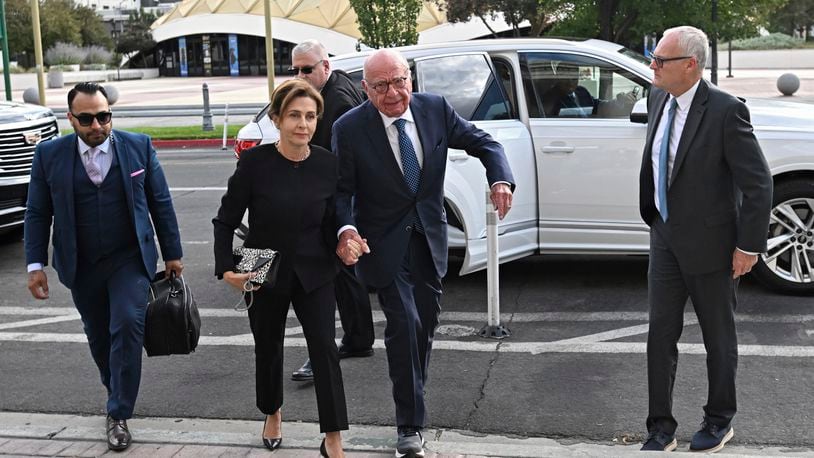 Rupert Murdoch, center, and his wife Elena Zhukova Murdoch arrive at the Second Judicial District Court in Reno, Nev., Monday Sept. 16, 2024. (AP Photo/Andy Barron)