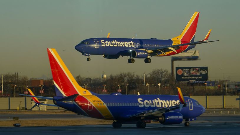 FILE - A Southwest Airlines plane prepares to land at Midway International Airport while another taxis on the ground, Feb. 12, 2023, in Chicago. (AP Photo/Kiichiro Sato, File)