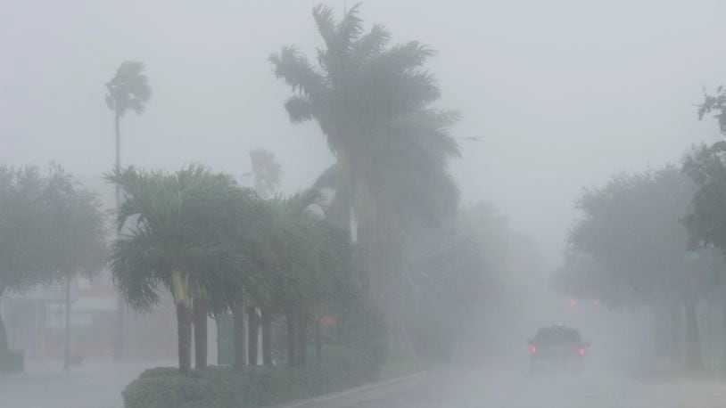 A Lee County Sheriff's officer patrols the streets of Cape Coral, Fla., as heavy rain falls ahead of Hurricane Milton, Wednesday, Oct. 9, 2024. (AP Photo/Marta Lavandier)