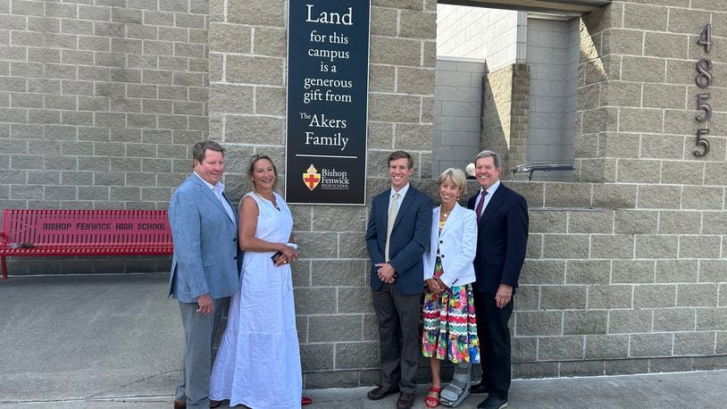 The Akers family was honored Friday morning for donating 66 aces that were used to build Fenwick High School that opened 20 years ago. The school unveiled a plaque near the entrance. From left: Bill Akers, Debby Akers, Drew Akers, Jody Akers and Jim Akers. RICK McCRABB/CONTRIBUTING REPORTER