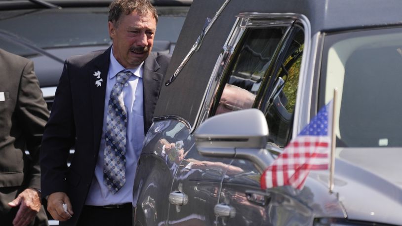 Guy Gaudreau looks into a hearse containing the remains of his son Columbus Blue Jackets hockey player John Gaudreau after his and his brother's Matthew Gaudreau funeral at St. Mary Magdalen Catholic Church in Media, Pa., Monday, Sept. 9, 2024. (AP Photo/Matt Rourke)