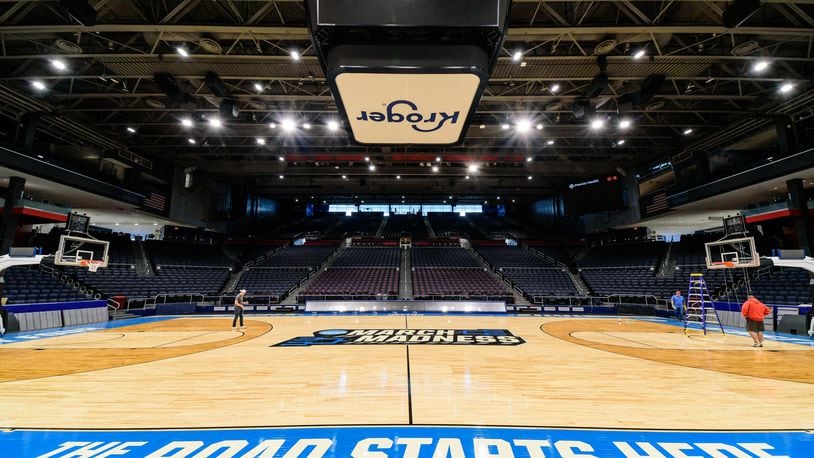 On St. Patrick's Day 2024, workers put the finishing touches on the basketball court installation for the First Four of the NCAA Division I Men’s Basketball Championship at UD Arena which will take place on March 19 & 20, 2024. TOM GILLIAM / CONTRIBUTING PHOTOGRAPHER