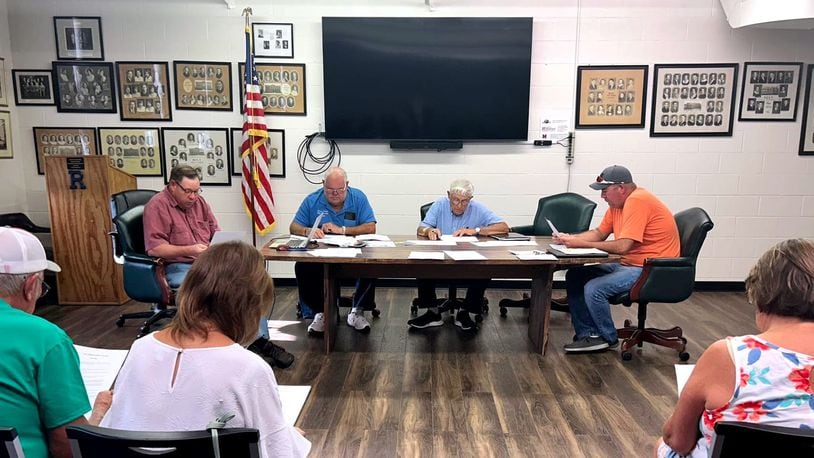 At a July 17 meeting, Ronald Tilford, Fiscal Officer (far left); Dennis H. Conrad Jr., Chair (middle left); C. Nicholas Schwab, Vice Chair (middle right) and Jeremy Sears, road superintendent (far right) discussed the agenda and previous meeting minutes. TAYLOR STUMBAUGH/OXFORD FREE PRESS