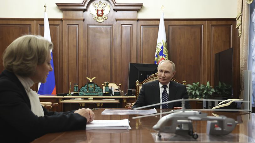 Russian President Vladimir Putin, right, speaks with Anna Popova, the Head of the Federal Service for the Oversight of Consumer Protection and Welfare, during their meeting at the Kremlin in Moscow, Russia, Monday, Sept. 16, 2024. (Alexander Kazakov, Sputnik, Kremlin Pool Photo via AP)