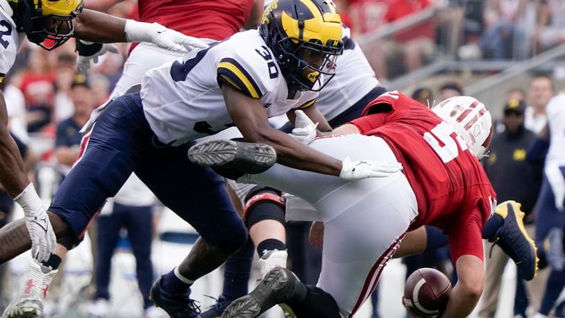 Michigan's Daxton Hill hits Wisconsin's Graham Mertz during the second half of an NCAA college football game Saturday, Oct. 2, 2021, in Madison, Wis. Mertz was hurt on the play and left the game. (AP Photo/Morry Gash)