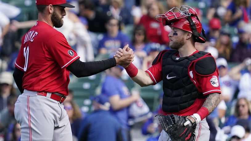 Cincinnati Reds relief pitcher Tejay Antone, left, celebrates with catcher Tucker Barnhart after they defeated the Chicago Cubs in a baseball game in Chicago, Sunday, May 30, 2021. (AP Photo/Nam Y. Huh)