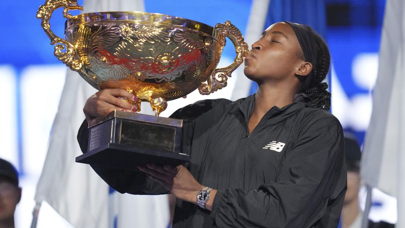 Coco Gauff of the United States kisses the trophy after defeating Karolina Muchova of Czech Republic in the women's singles final match at the China Open tennis tournament at the National Tennis Center in Beijing, Sunday, Oct. 6, 2024. (AP Photo/Achmad Ibrahim)