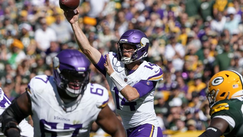 Minnesota Vikings quarterback Sam Darnold (14) throws a pass during the first half of an NFL football game against the Green Bay Packers, Sunday, Sept. 29, 2024, in Green Bay, Wis. (AP Photo/Morry Gash)