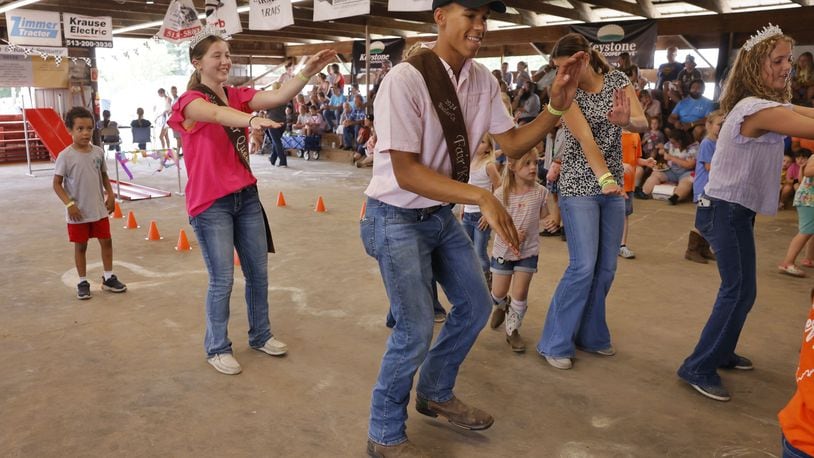 Butler County Fair Queen Emma Puckett, left, and King Brayden Kidd lead line dancing with kids Wednesday, July 24, 2024 at Butler County Fair in Hamilton. NICK GRAHAM/STAFF