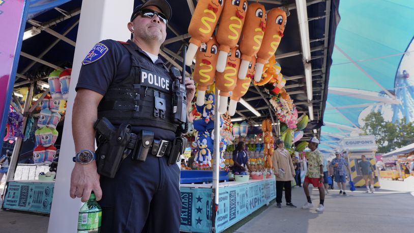 Dallas police officer Luna, stands on watch on the Midway at the State Fair of Texas in Dallas, on Friday, Sept. 27, 2024. (AP Photo/Tony Gutierrez)