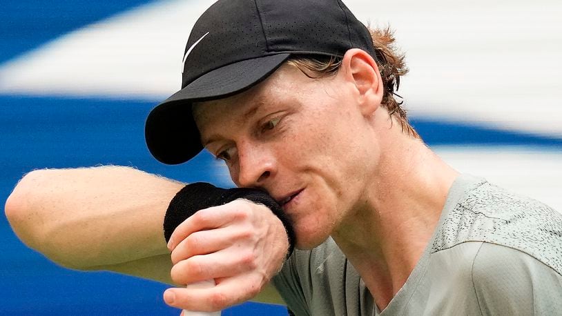 FILE - Jannik Sinner, of Italy, wipes sweat from his face between serves to Mackenzie McDonald, of the United States, during the first round of the U.S. Open tennis championships, Tuesday, Aug. 27, 2024, in New York. (AP Photo/Kirsty Wigglesworth, File)