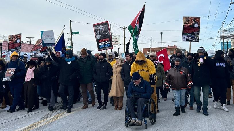People braved the frigid weather Monday, Jan. 15, 2024, to participate in the MLK Day march in Dayton in celebration of civil rights icon Martin Luther King, Jr. EILEEN McCLORY/STAFF