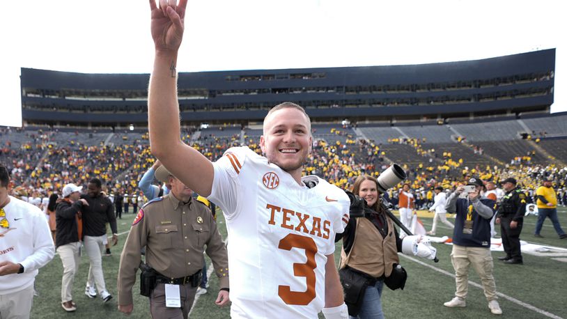 Texas quarterback Quinn Ewers smiles while acknowledging the crowd after an NCAA college football game against Michigan in Ann Arbor, Mich., Saturday, Sept. 7, 2024. (AP Photo/Paul Sancya)