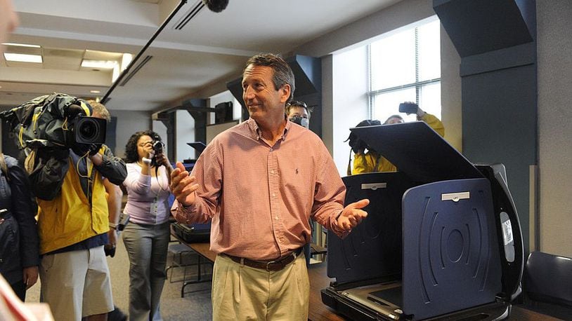 Former South Carolina Gov. Mark Sanford throws up his arms after casting his vote in the special election runoff with Elizabeth Colbert Busch for a seat in the 1st Congressional District May 7, 2013 in Charleston, South Carolina.