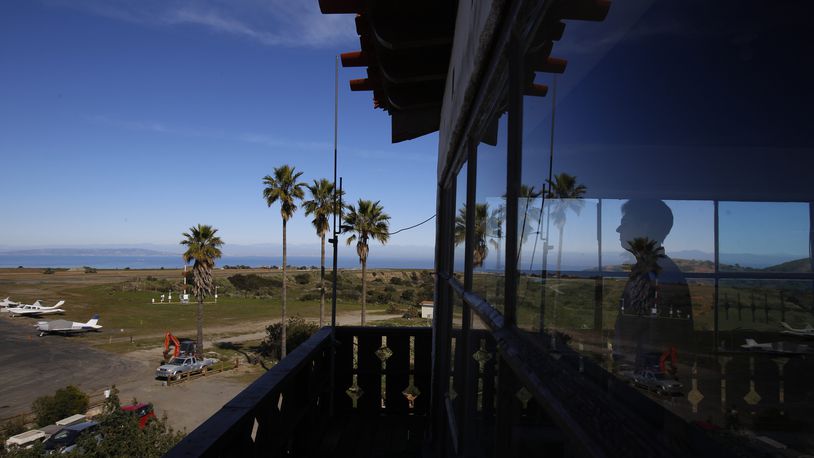 FILE - Catalina Island Conservancy Airport Manager Justin Bollum looks out of the airport tower as U.S. Marines and Navy Seabees rebuild the mountaintop runway on Santa Catalina Island, Calif., Friday, Jan. 25, 2019. (AP Photo/Damian Dovarganes, File)