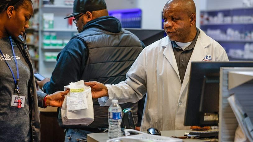 Ziks Family Pharmacist, Nnodum Iheme, right, works with pharmacy technician, Joy Duaka at the pharmacy on East Third St. Wednesday November 30, 2022. Starting in January 2025, Medicare Part D enrollees will have their out-of-pocket spending for prescription medication capped at $2,000 a year. JIM NOELKER/STAFF FILE