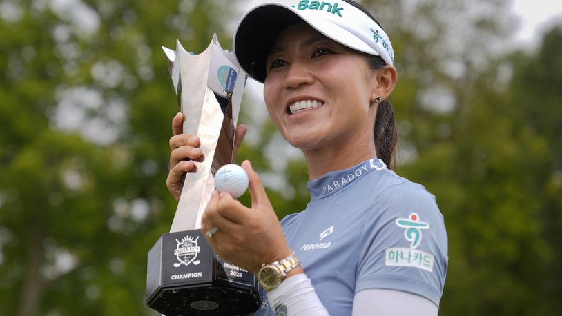 Lydia Ko, of New Zealand, poses for photos with the trophy and a golf ball after winning the LPGA Kroger Queen City Championship golf tournament at TPC River's Bend in Maineville, Ohio, Sunday, Sept. 22, 2024. (AP Photo/Carolyn Kaster)