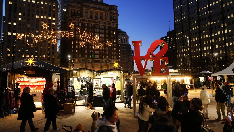 FILE - Shoppers visit the Christmas Village in Philadelphia, Dec. 13, 2023. (AP Photo/Matt Rourke, File)