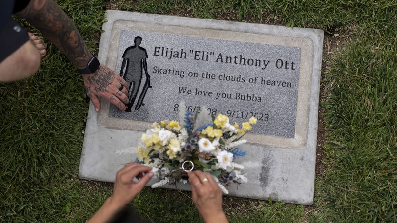 Mikayla Brown and her husband, Tyler, visit the grave of their son, Elijah, who died of a fentanyl overdose at 15, in Paso Robles, Calif., Friday, Aug. 2, 2024. (AP Photo/Jae C. Hong)