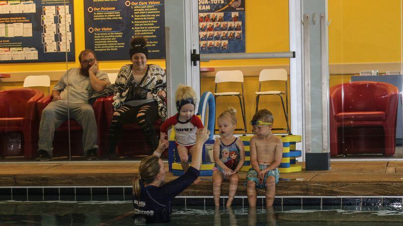 Parker, Garrett and Charlotte receive swim lesson from … at the Aqua-Tots Swim School in Beavercreek. The business reopened at the beginning of October after closing for repairs following the Memorial Day tornado. RICHARD WILSON/STAFF Swaney, Cary Barnhart