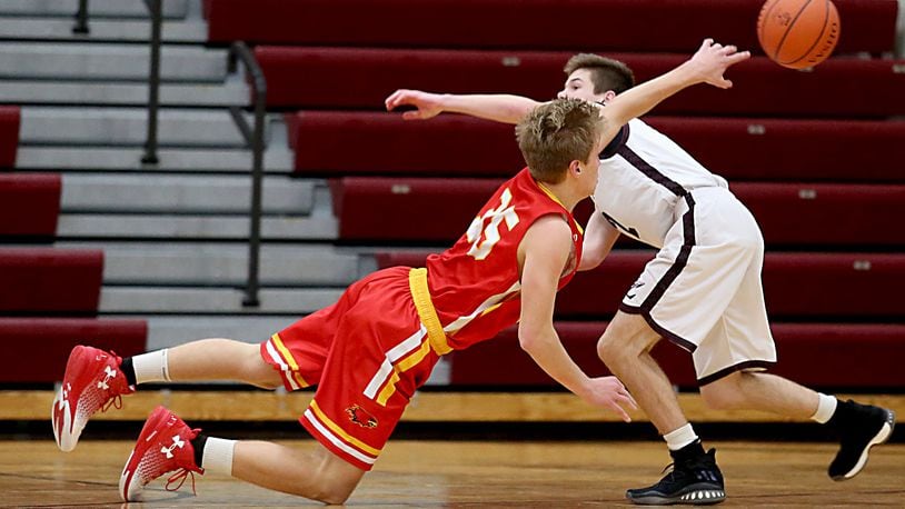 Fenwick forward Luke Bradshaw gets off a pass as Lebanon guard Sammy Stotts pressures during their game at Lebanon on Dec. 17, 2016. COX MEDIA FILE PHOTO