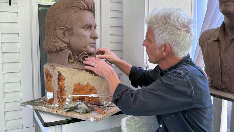 FILE - Artist Kevin Kresse, works on a clay bust of Johnny Cash, April 23, 2024 in Little Rock, Ark. Kresse's full sculpture of Cash will be unveiled at the U.S. Capitol as part of the Statuary Hall collection. (AP Photo/Mike Pesoli, File)