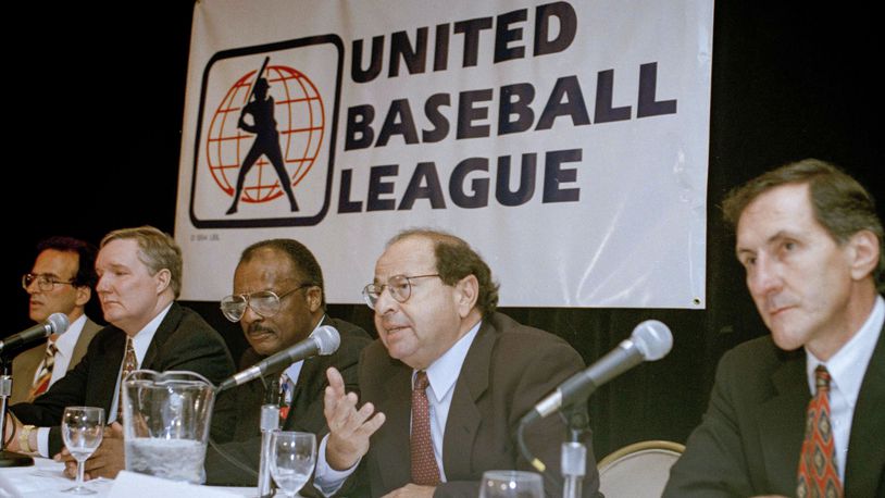 FILE - Agent Dick Moss, second from right, Donald Fehr's predecessor as general counsel of the Major League Players Association, answers a question at a New York news conference, Nov. 1, 1994, announcing the formation of the United Baseball League. From left are Smith College economics professor Andrew Zimbalist; Rep. John Bryant, D-Texas; former major leaguer Curt Flood; Moss, and Robert Mrazek. (AP Photo/Marty Lederhandler, File)