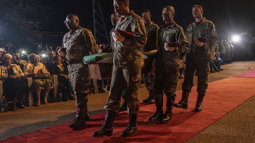 One of the remains of South Africans who died while exiled in Zimbabwe and Zambia during the struggle against white minority rule arrive at the Waterkloof Air Force Base in Pretoria, South Africa, Wednesday, Sept. 25, 2024. (AP Photo/Shiraaz Mohamed)