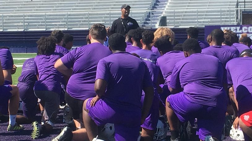 Don Simpson addresses his Middletown football team after a recent practice session at Barnitz Stadium in Middletown. RICK CASSANO/STAFF