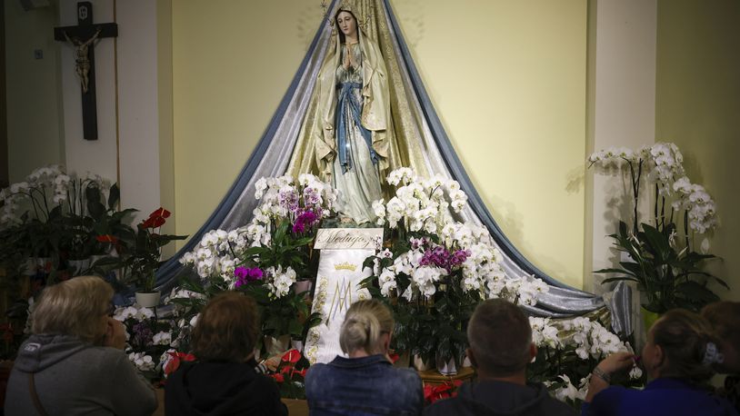 Pilgrims recited their prayers next to the statue of the Virgin Mary inside the St. James Church in Medjugorje, Bosnia, Thursday, Sept. 19, 2024. (AP Photo/Armin Durgut)